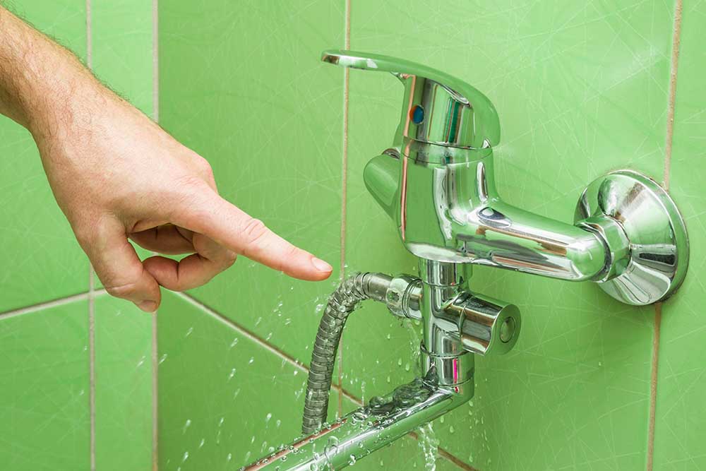 homeowner trying to fix a leaky faucet homeowner trying to fix a leaky faucet